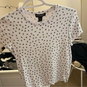 Cute white top with little flowers. Brand new never worn but I took the tags off